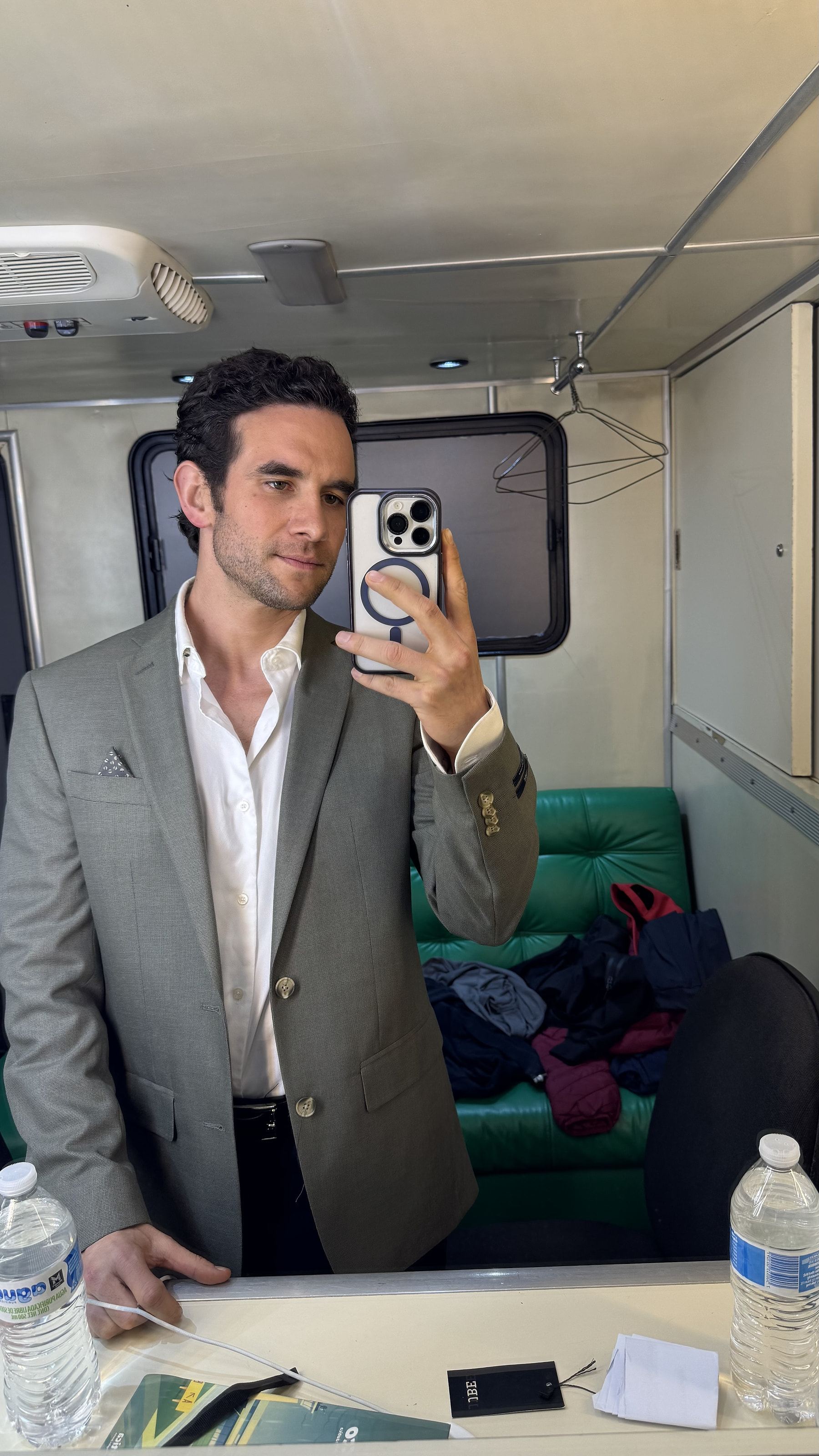 Marco Valdés con saco gris frente al espejo de un camerino